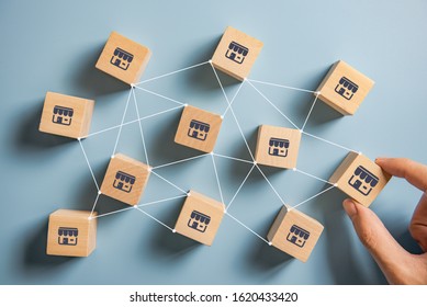 Woman hand choose wood blog with franchise marketing system in global network connection. Franchise business concept.