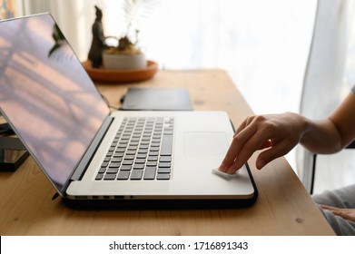 Woman Hand Cleaning Computer Laptop With Antibacterial White Tissue Or Disposable Wipes