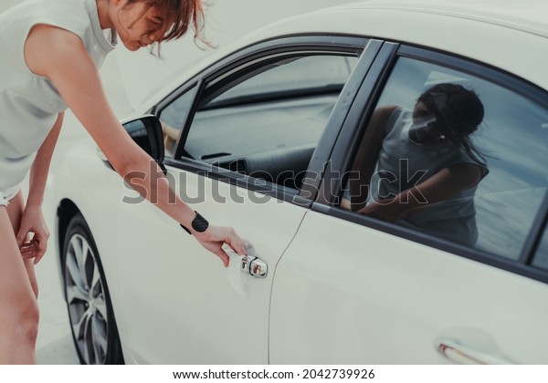 woman hand cleaning on car door\
handle, outside car against Novel coronavirus or Corona Virus\
Disease (Covid-19). Antiseptic, Hygiene and Healthcare\
concept