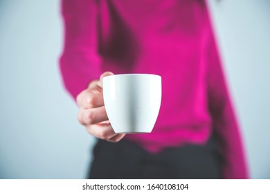 woman hand cup of coffee on grey background - Shutterstock ID 1640108104
