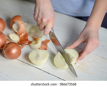 Woman Hand Cut Fresh Onion On White Table