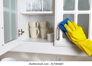 Woman Hand Doing Chores In The Kitchen At Home , Cleaning Kitchen Dresser