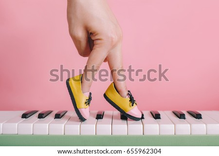 woman hand finger walking on piano with shoe concept, Music lesson school education concept, Dance exercise for good healthy.