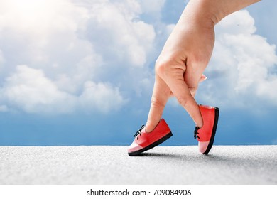 Woman Hand Finger Walking With Shoe Concept, Walking On Sky, Traveler Adventure Outdoor Summer Vacations Concept, Healthy Lifestyle Concept. 