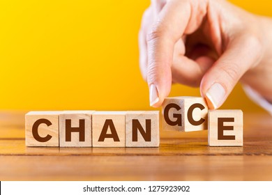 Woman Hand Flip Wooden Cube With Word Change To Chance Letters