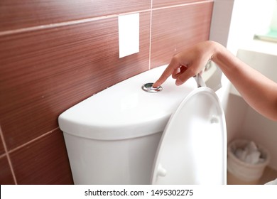 Woman Hand Flush Toilet After Using