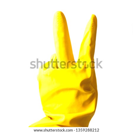 Woman hand gesturing viktory in yellow vinyl or rubber glove for cleaning isolated on white background