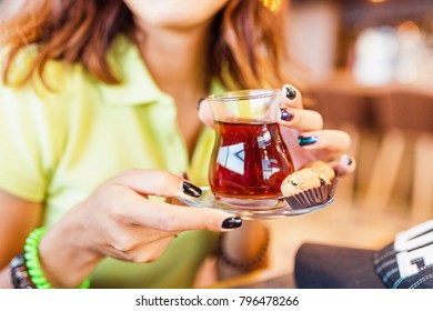 Woman Hand With A Glass Of Turkish Tea In Cafe