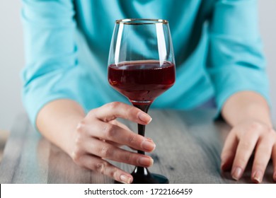 woman hand glass of wine on the desk background
