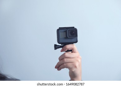 Woman Hand Gopro On Grey Wall Background