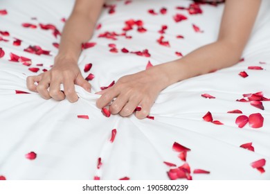 Woman Hand Grasping White Sheet. Couple Making Love Or Having Sex In Bedroom.