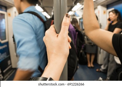 woman hand handrail or hold strap while standing in sky train or public transportation.soft focus