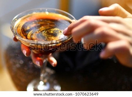 Woman Hand Hold Glitter Caramel Liquor In Restaurant Bar Cafe Closeup Composition