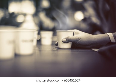 Woman Hand Hold Paper Cup Of Water With Blur Omage Background