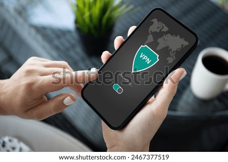 woman hand hold phone with app vpn creation Internet protocols for protection private network over table in cafe