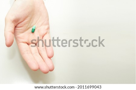 woman hand hold pill supplement antioxidant vitamin mineral capsule  before take medicine capsule for health care copy space