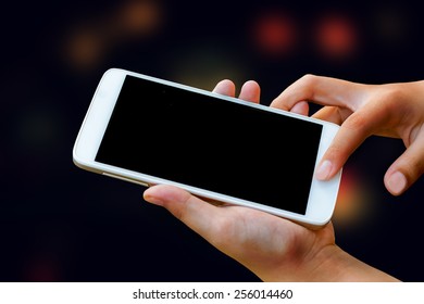 Woman Hand Hold And Touch Screen Smart Phone, Tablet,cellphone On Abstract Blurred Bokeh Of City Night Light Background Background.