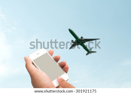 woman hand hold and touch screen smart phone,tablet,cellphone in the airport terminal 