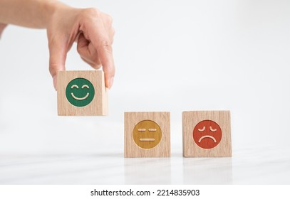 Woman Hand Hold Wooden Block With Icon Happy Smiley Face. Mental Health Assessment And Medical Concept.