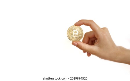 Woman hand holding bitcoin coin, isolated on white background. Copy space. Crypto currency concept. Clipping path. - Shutterstock ID 2019994520