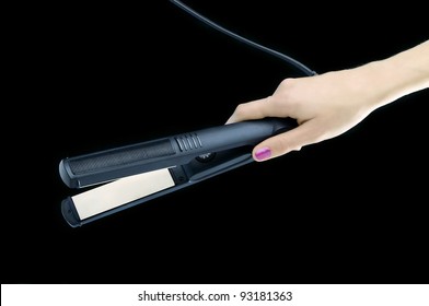 Woman Hand Holding A Black Hair Straightener