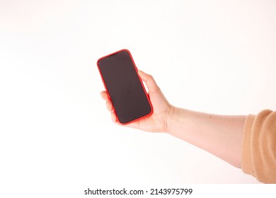 Woman hand holding black smartphone isolated on white background, clipping path