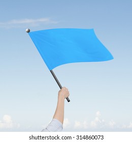 Woman Hand Holding Blank Blue Flag, On Nature Sky Clouds Background.