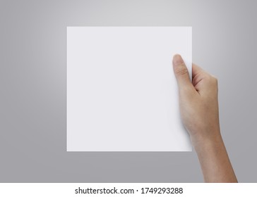 Woman Hand Holding Blank Paper Sheet Square Size With Copy Space.