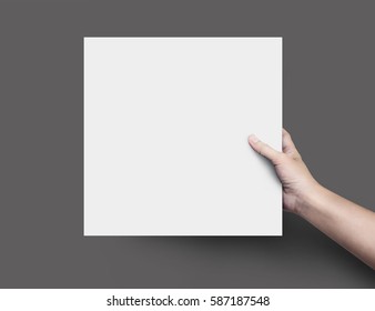 Woman Hand Holding Blank Paper Sheet Square Size Or Design Paper On Black Background.