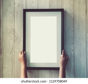 Woman Hand Holding Blank Photo Frame.