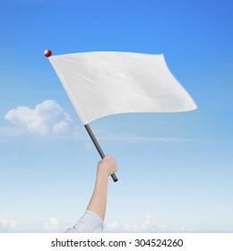 Woman Hand Holding Blank White Flag, On Nature Sky Clouds Background.