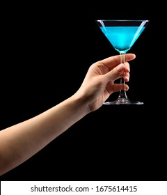 Woman Hand Holding Blue Martini Glass Isolated On Black Background With Clipping Path