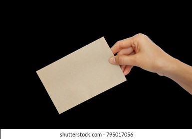 Woman Hand Holding Brown Envelope Isolated On Black Background