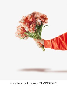 Woman Hand Holding Bunch Of Orange Flowers At White Background. Front View.