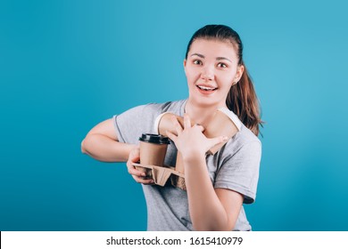 Woman hand holding a lot of Coffee paper cup on blue background.