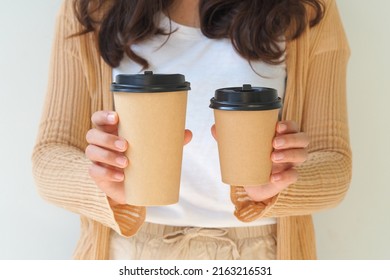 Woman Hand Holding Coffee Paper Cup On White Background.