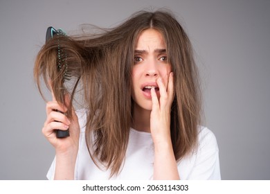 Woman hand holding comb with serious hair loss problem for health care shampoo. - Shutterstock ID 2063114303