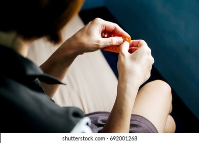 Woman hand holding contraceptive pill ready to eat.