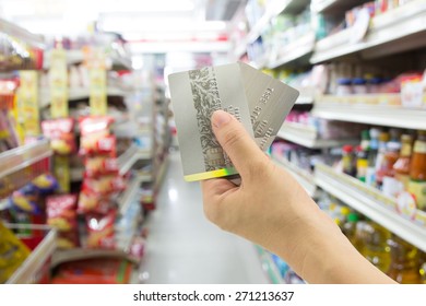 Woman Hand Holding Credit Card At Convenience Store