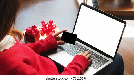 Woman Hand Holding Credit Card For Business Online Shopping With Laptop Computer Blank Screen, Black Friday Sale