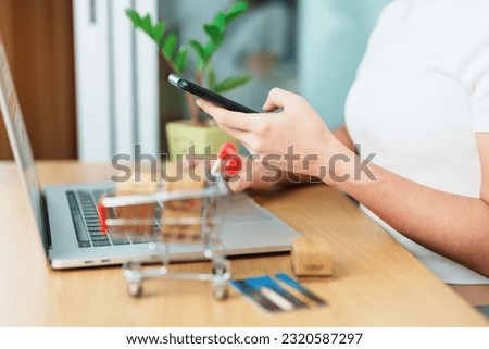 woman hand holding credit card and using laptop with mobile phone for online shopping while making order. Marketplace platform website, technology, ecommerce, shipping delivery and online payment