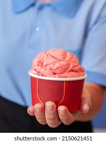 Woman Hand Holding Cup With Strawberry Ice Cream. Space For Text.