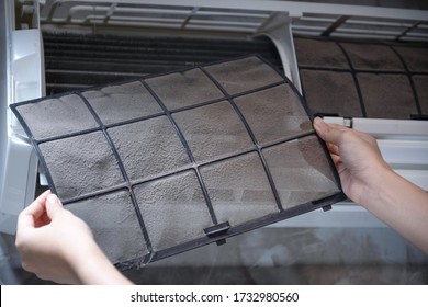 Woman Hand Holding Dirty Home Air Conditioner Filter For Remove For Cleaning Air Conditioner.