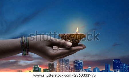 Woman hand holding Diya oil lamps for the Diwali festival. Diwali Festival. The Hindu Festival of Lights celebration