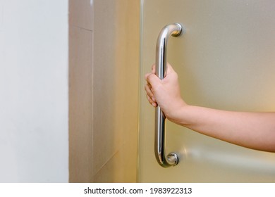 Woman Hand Is Holding Door Handle While Opening A Door, Close-Up Of Waitress Women Open Door For Customer In Office Building. Interior Decorative Design Private Room For Security Residential.