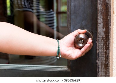 Woman Hand Holding Doorknob Represent Opening Or Closing Door