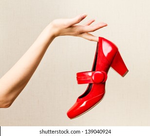 Woman Hand Holding Dress Red High Heels Shoe.