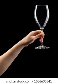 Woman Hand Holding Empty Wine Glass Isolated On Black Background.