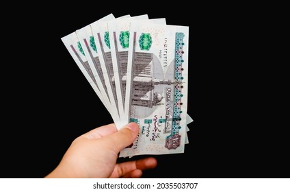 woman hand holding five hundreds  Egyptian bounds isolated on black background - Shutterstock ID 2035503707
