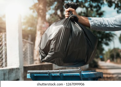 Woman Hand Holding Garbage Black Bag Put In To Trash